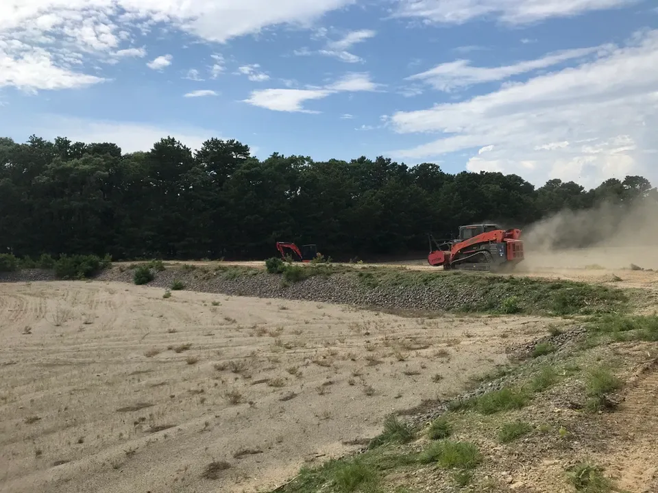 Skid Steer Driving Down Sandy Trail