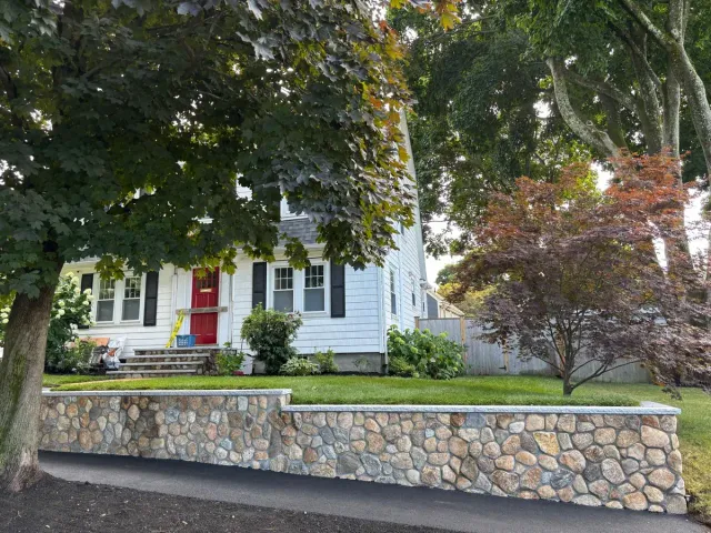 Residential retaining wall installation at a Massachusetts home.