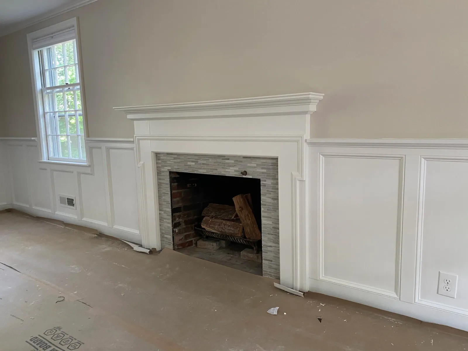 New wainscoting and an updated mantle in a formal living room.
