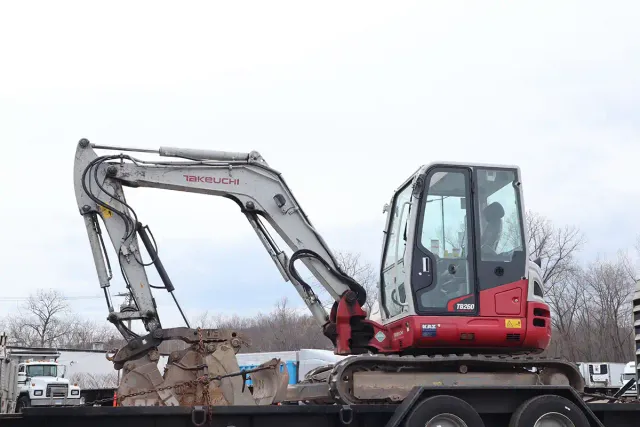 Takeuchi TB260 excavator on trailer showing the front bucket attachment