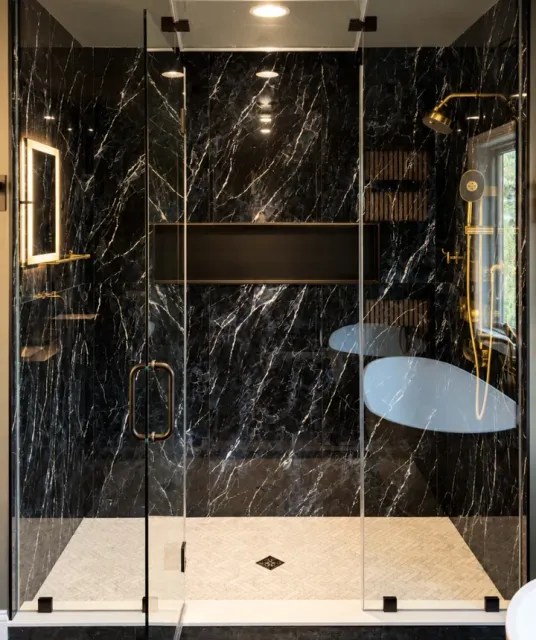 Luxury curbless walk-in shower with large-format marble-look porcelain tile in a Fairfield County, CT bathroom
