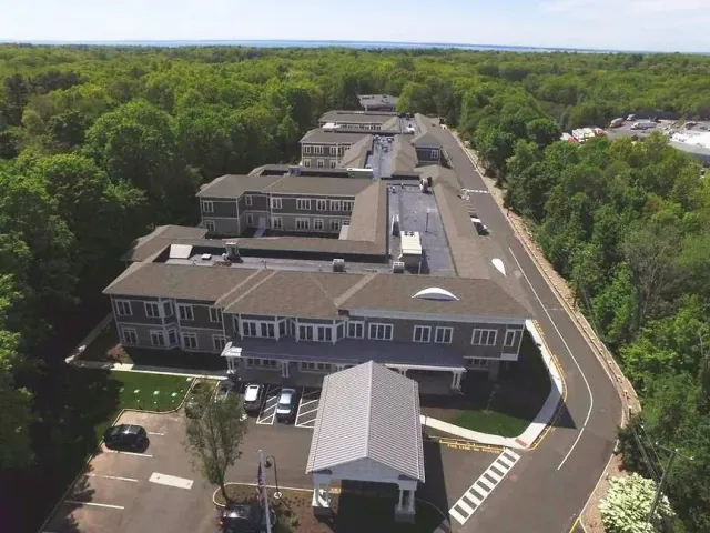 An aerial view of a large building surrounded by trees