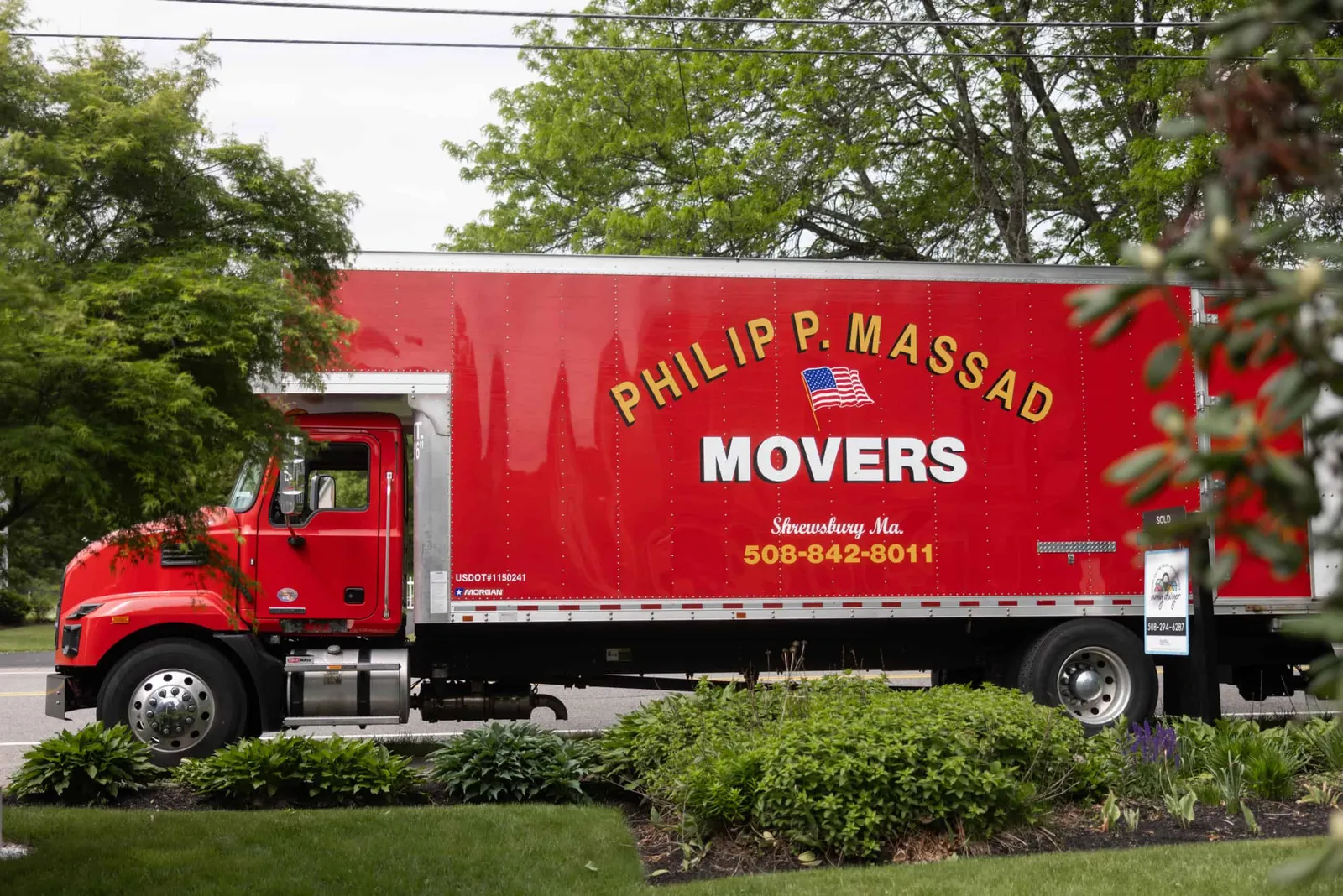 A red truck with the words phillip massad movers on it.
