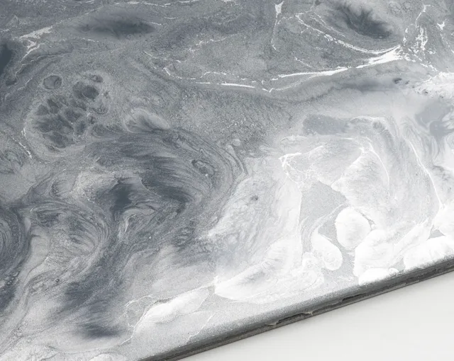 Close-up view of a gray marble surface with natural swirling and veining patterns.