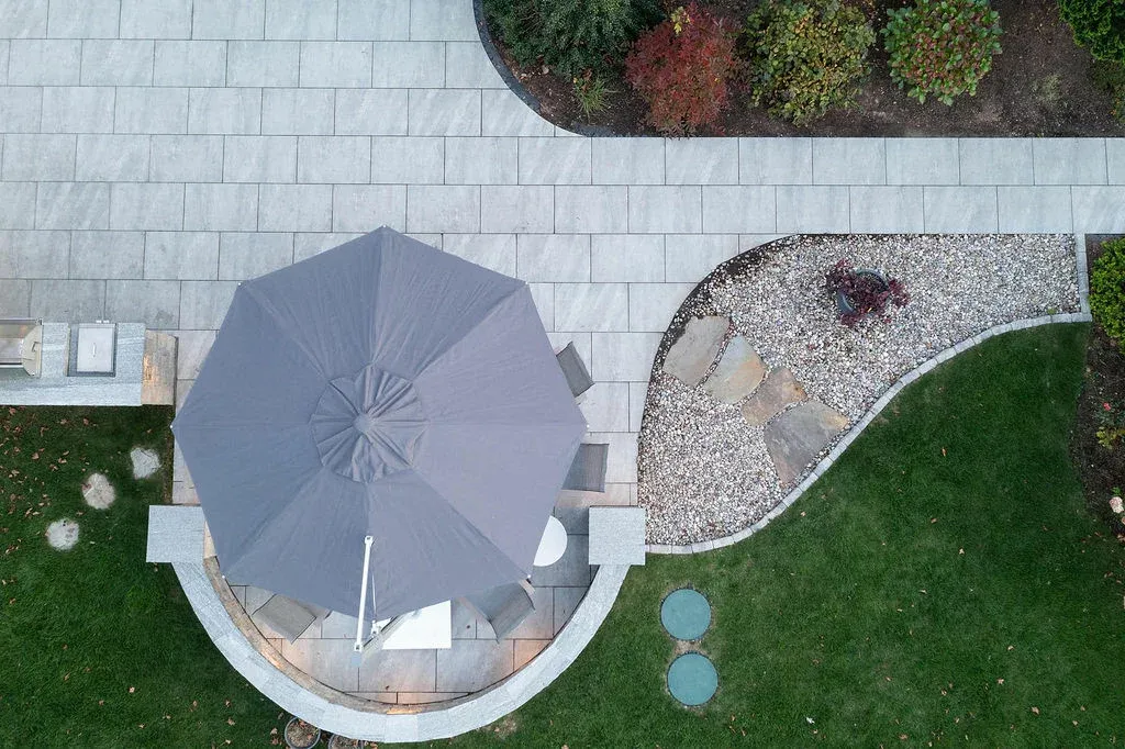 Porcelain patio and walkway with built-in seating wall in Sharon, Massachusetts