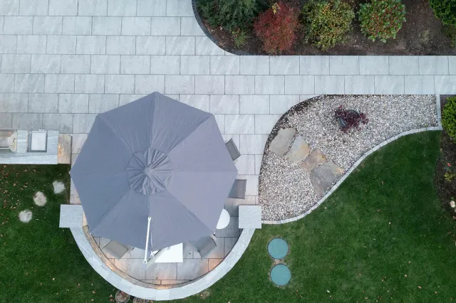 Porcelain patio and walkway with built-in seating wall in Sharon, Massachusetts