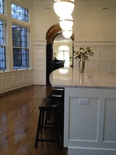 a kitchen with a large island and stools
