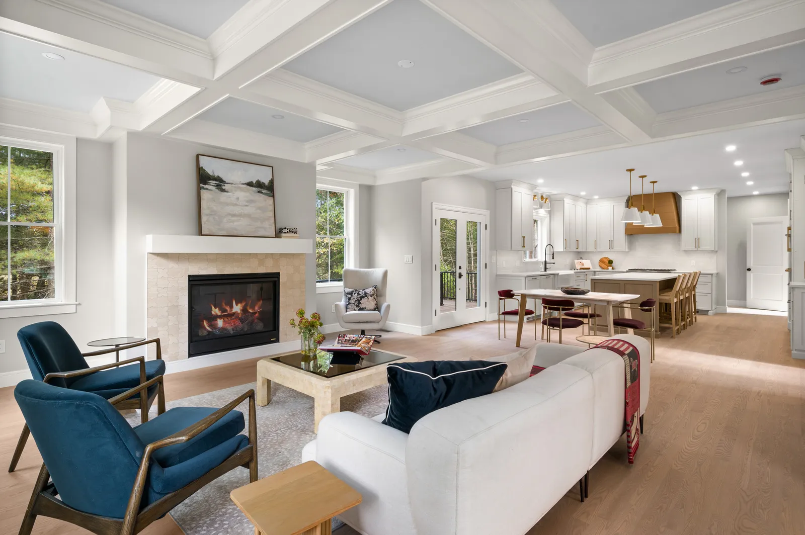Coffered-ceiling great room opening to a custom kitchen