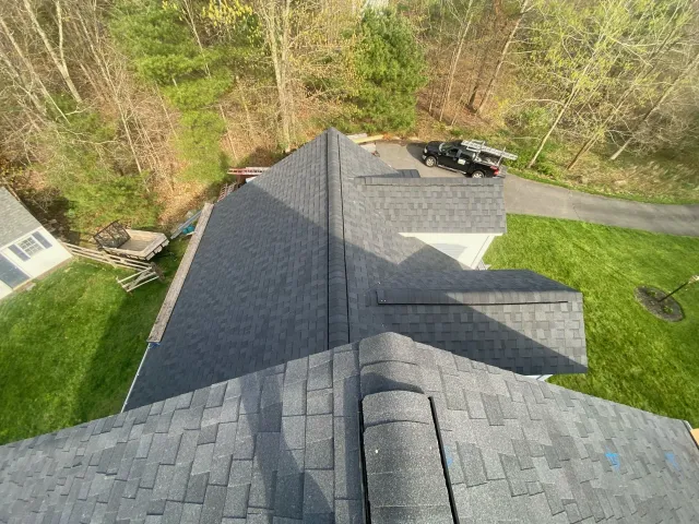 top view of bluish gray roof with parked car