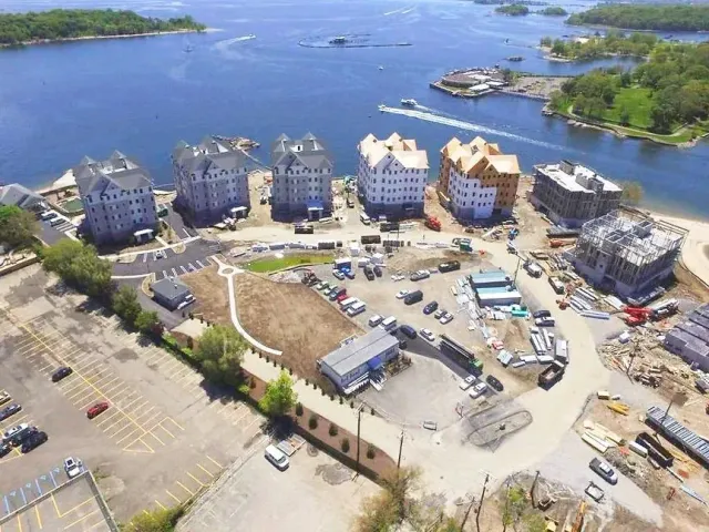 An aerial view of a residential area next to a body of water