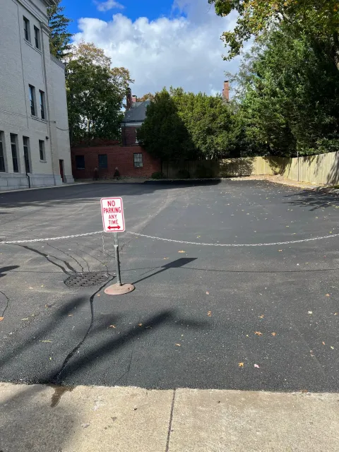Black asphalt parking lot with a
