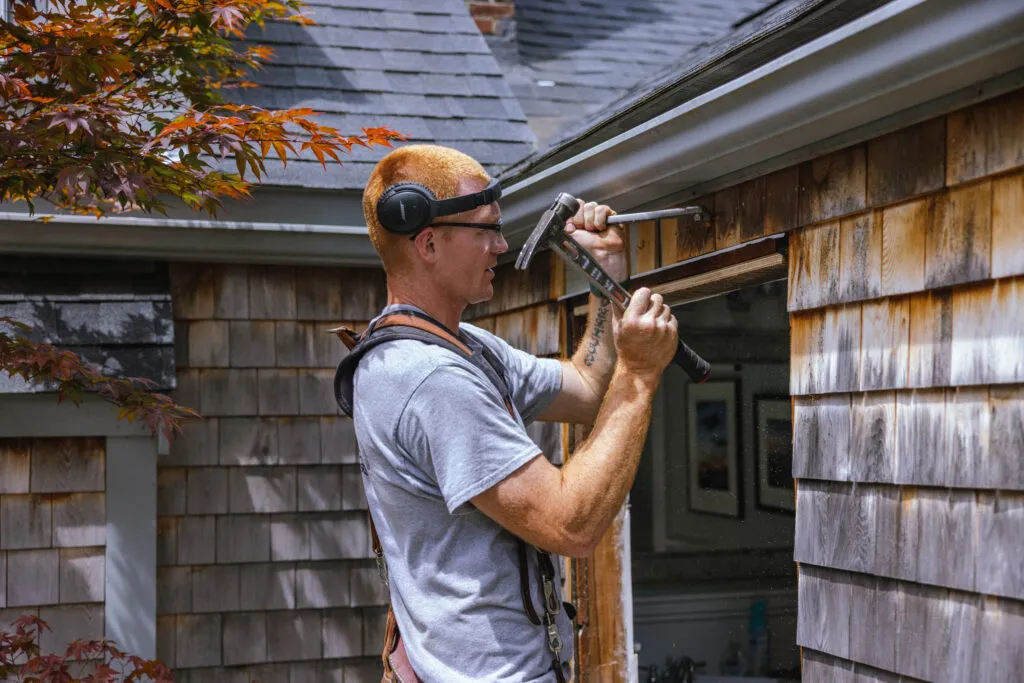 a carpenter installing a window