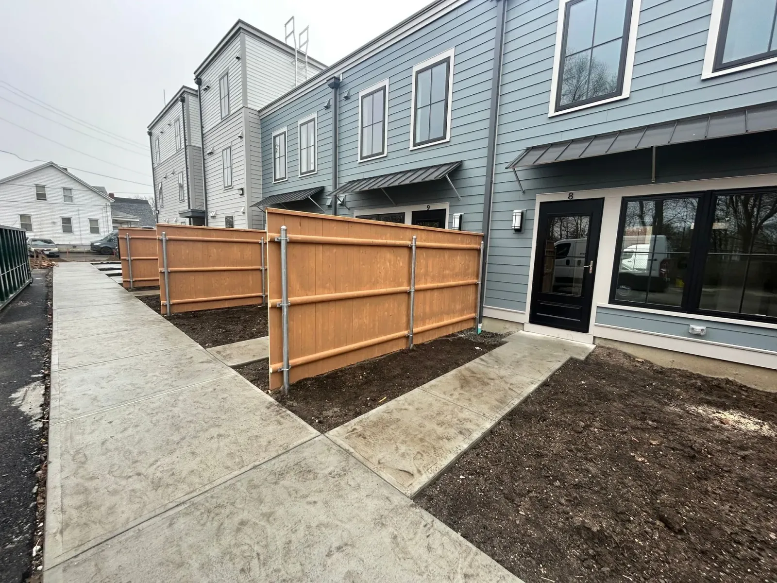 A building with a wooden fence in front of it.