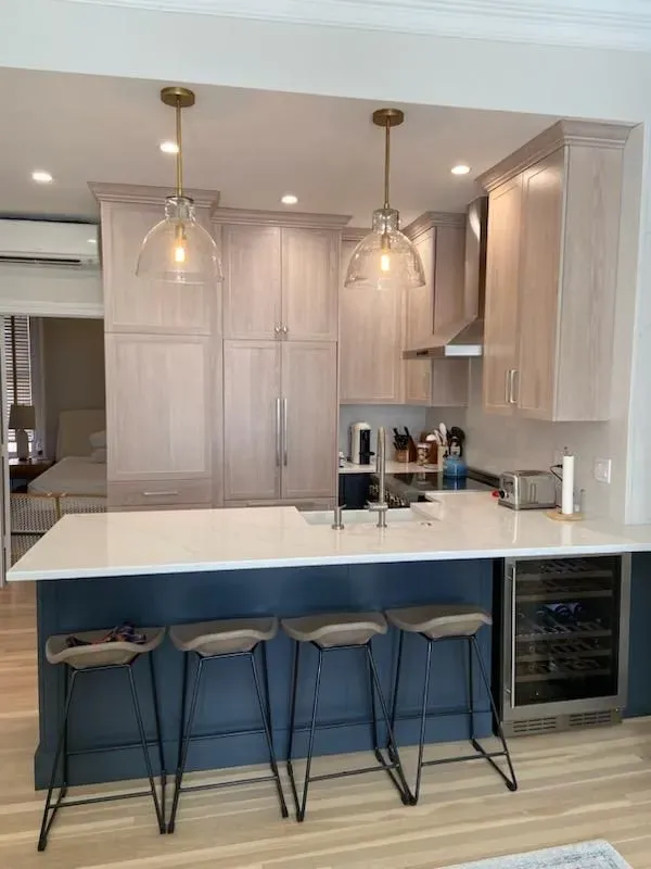 A kitchen with a large island and stools