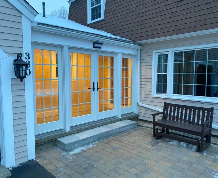 Completed breezeway addition with French doors and paver entry by SJ Wilson Construction Whitman MA.