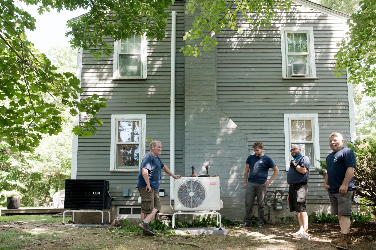 Forge HVAC technician hanging up a mini-split for a heat pump installation