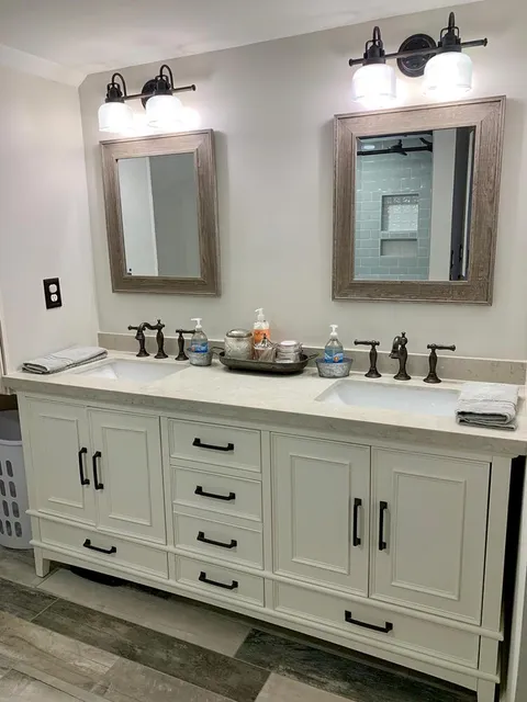 Interior shot of remodeled bathroom featuring double sink vanity
