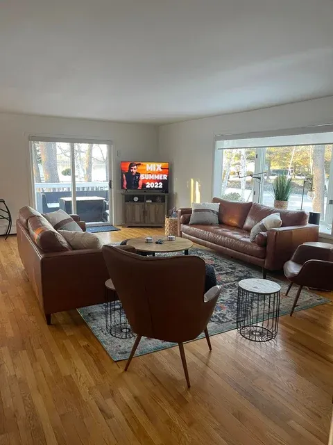 Immaculate living room with brown leather furniture — deep cleaning service Raymond Maine