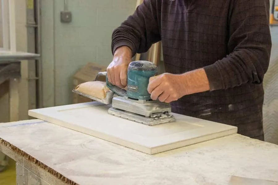 Man using an electric sander