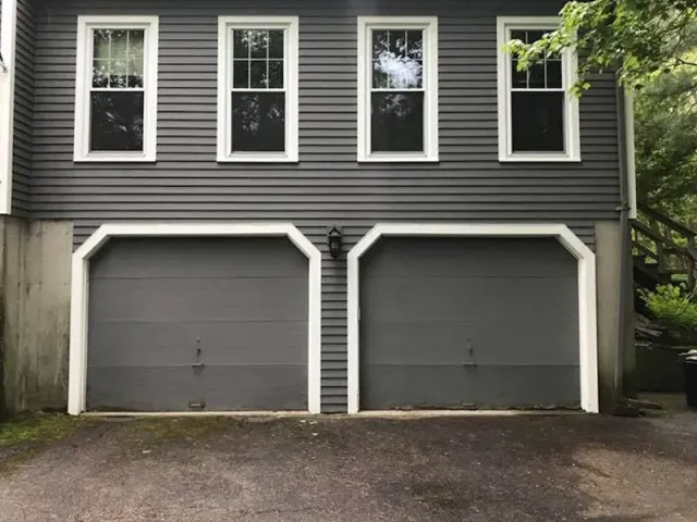 A house with two garage doors and three windows