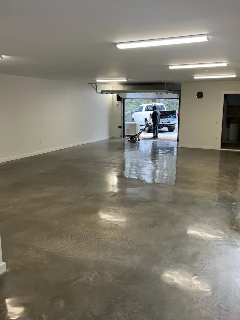 Empty garage with custom polished concrete floor.