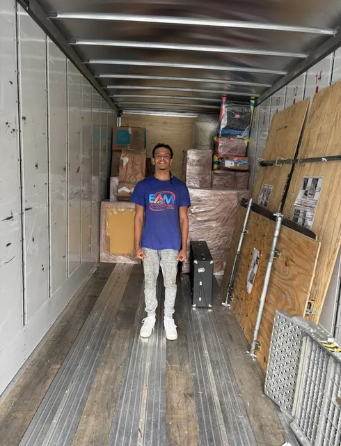 EAM Moving crew member inside a fully loaded and secured long-distance moving trailer