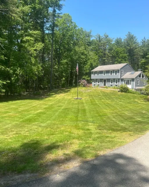 Front yard grass cut with clean edging in Westford, MA by Gardner’s Landscaping, LLC