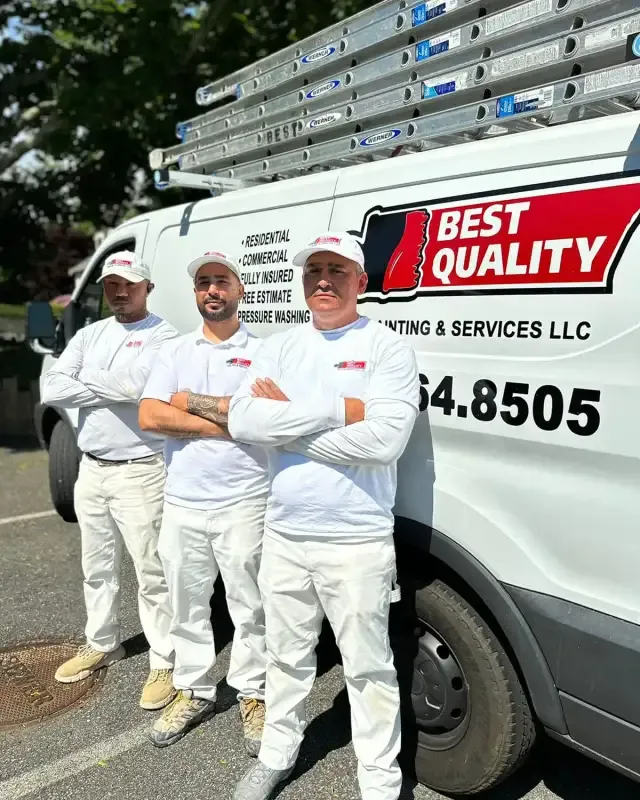 Best Quality Painting crew standing together at a completed job site