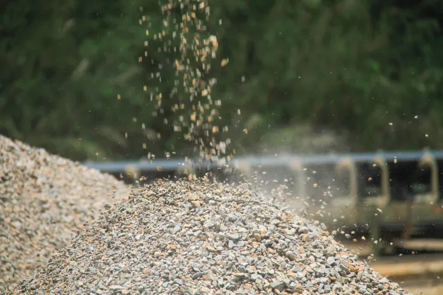 A pile of crushed gravel and aggregates of varying particle sizes, shown in detail at a construction site