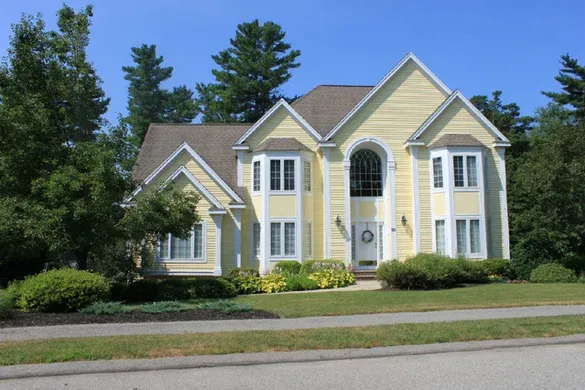 Yellow custom colonial with arched Palladian window