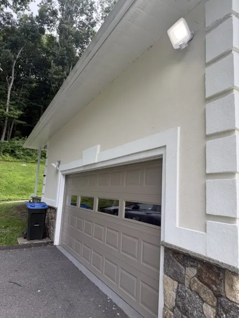 Masonry quoins and stone veneer base on a stucco garage