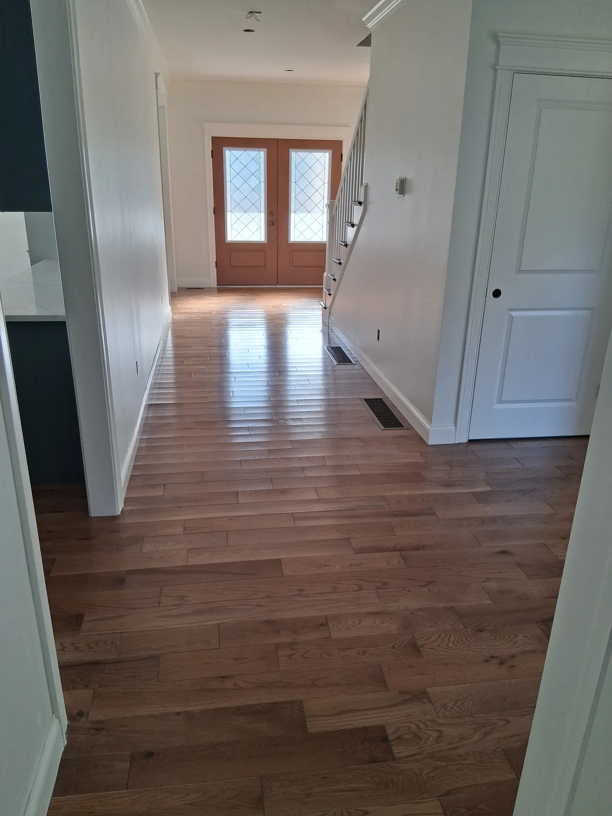 Interior hallway with fresh white paint in Massachusetts residence - interior painting contractors