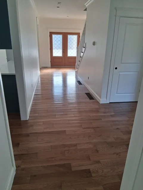 Interior hallway with fresh white paint in Massachusetts residence - interior painting contractors