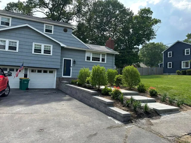 Thick striped green lawn in front of a New England colonial home