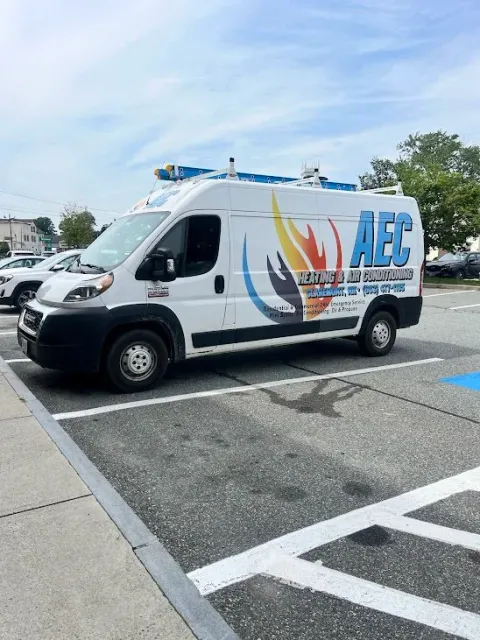AEC Heating & Air Conditioning service van parked in a lot, featuring the company’s colorful logo and ‘Heating & Air Conditioning’ text on the side.