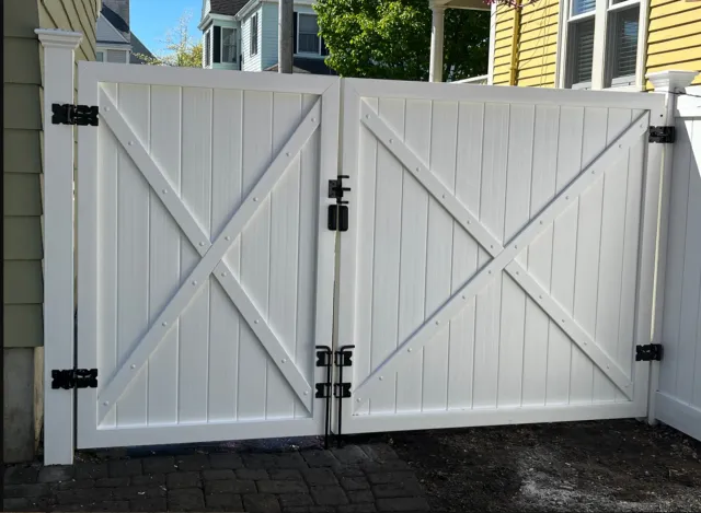 A white wooden gate with a cross on it