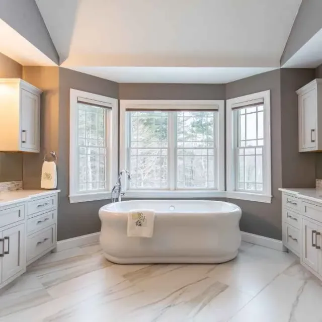 An expansive bathroom showcasing a bathtub alongside a sleek sink.