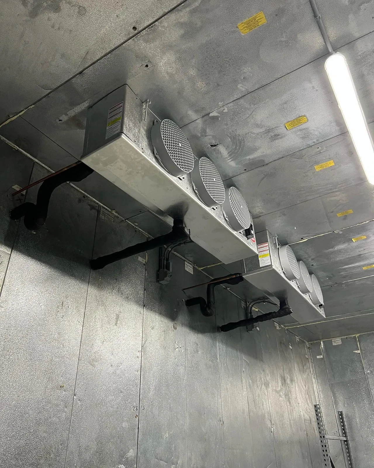 A room with a ceiling that has a lot of fans on it.