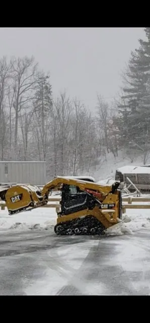 CAT skid steer with plow