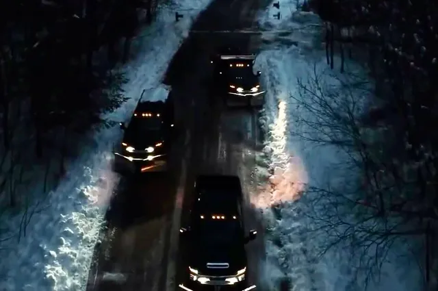 Fleet of trucks equipped for snow plowing on a residential street at night, part of Perfect North Lawn Care’s winter services in New Hampshire.
