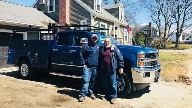 Gary & Justin Scalese of S&S Overhead Door in Waltham, MA posing in front of their company truck.