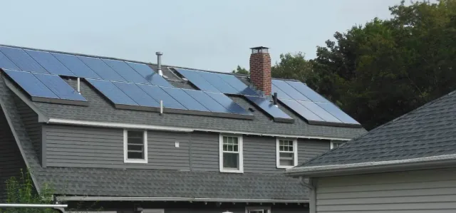A house with a lot of solar panels on the roof