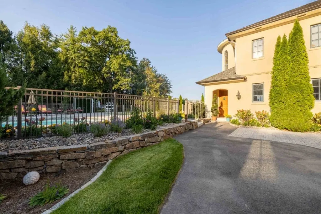Rye, NH landscape design: driveway plantings and stone wall