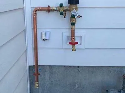 Exterior copper supply and backflow assembly