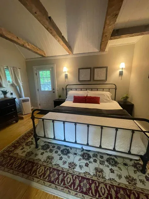 Spotless bedroom with iron bed frame — house cleaner near Casco Bridgton Maine