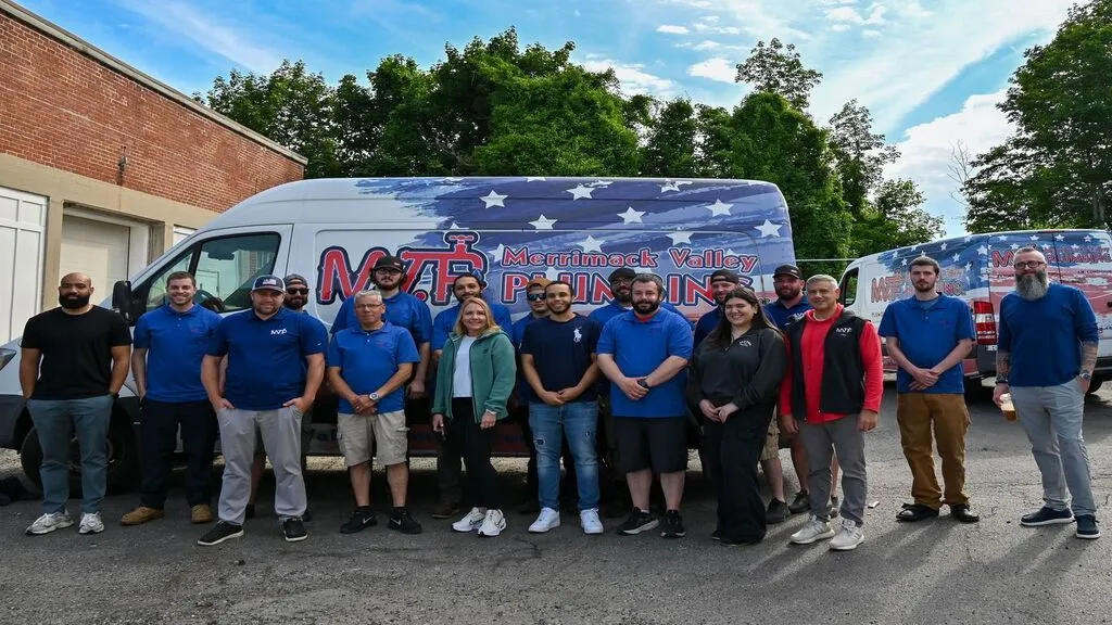 Team in front of the Merrimack Valley Plumbing branded vans