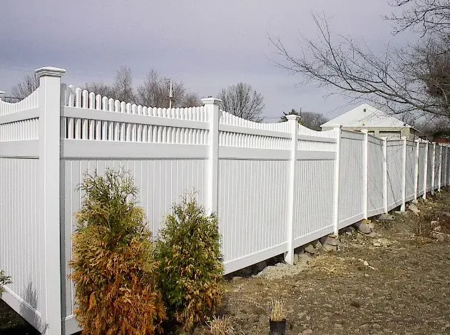 White vinyl picket fence along a yard