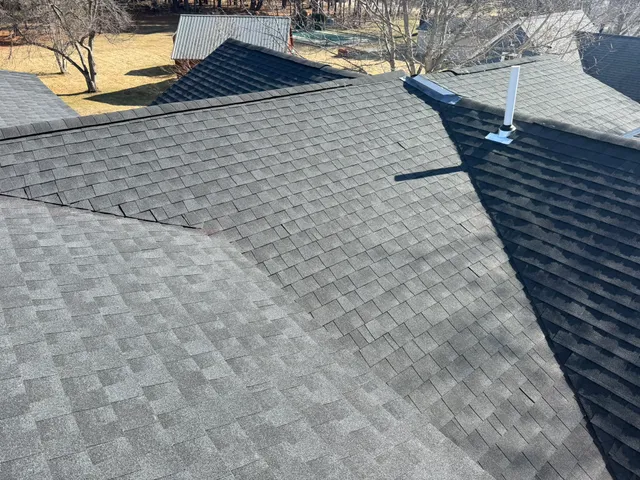 Close-up view of professional GAF Timberline HDZ shingle installation showing clean ridge line work