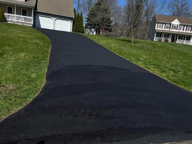 Asphalt sealcoating applied on a Massachusetts driveway