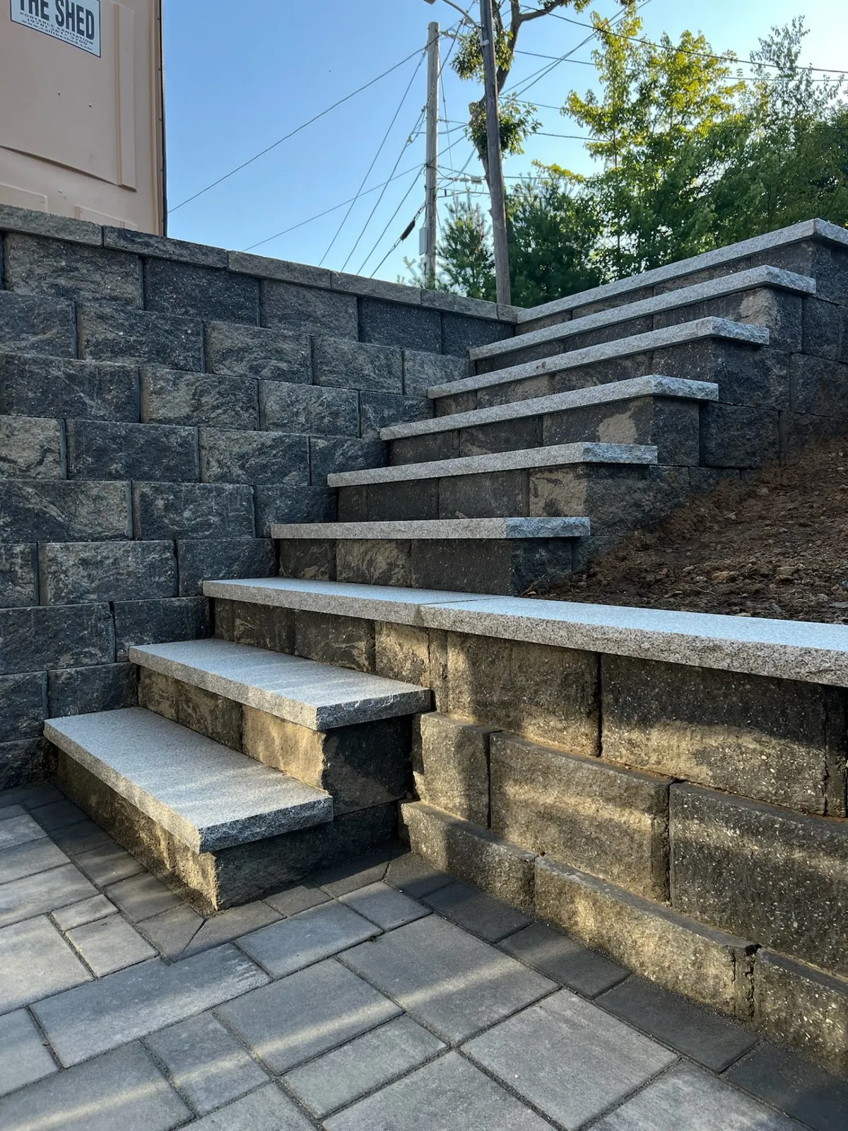 Stone retaining wall with built-in granite steps